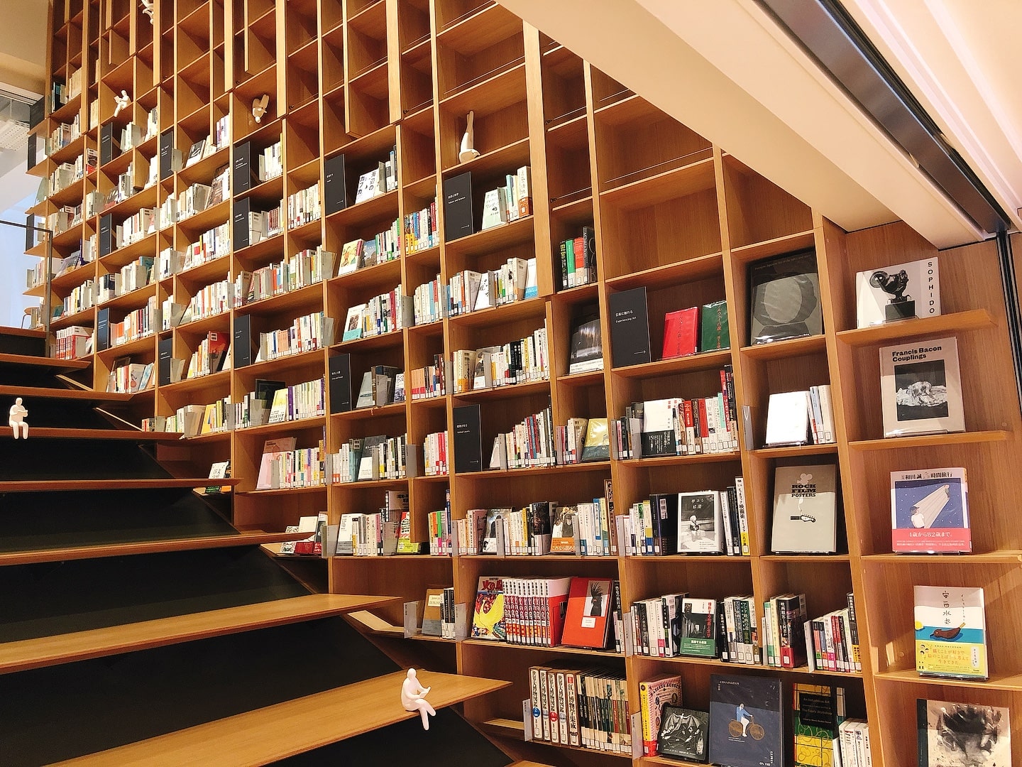Themed books lining Stair Bookshelf